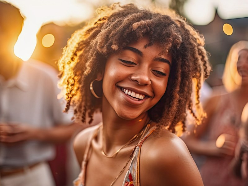 Frau im Sonnenuntergang am tanzen und lachen