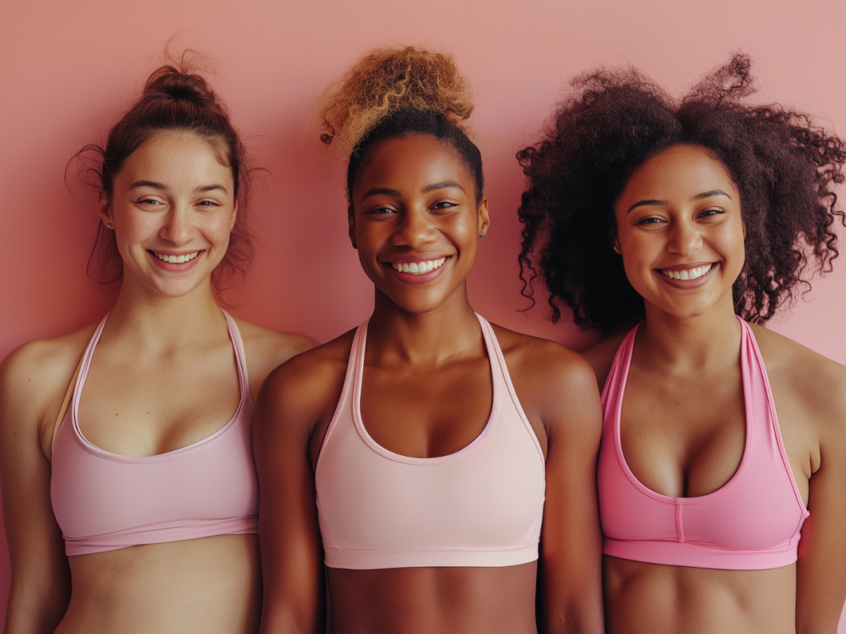 Drei KI-generierte Frauen vor einem pinken Hintergrund in Sportklamotten, die in die Kamera lächeln.