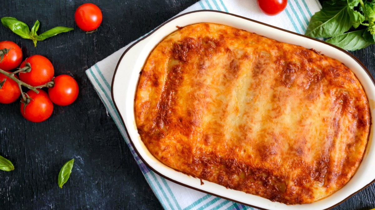 Cannelloni mit Käse überbacken in weißer Auflaufform.