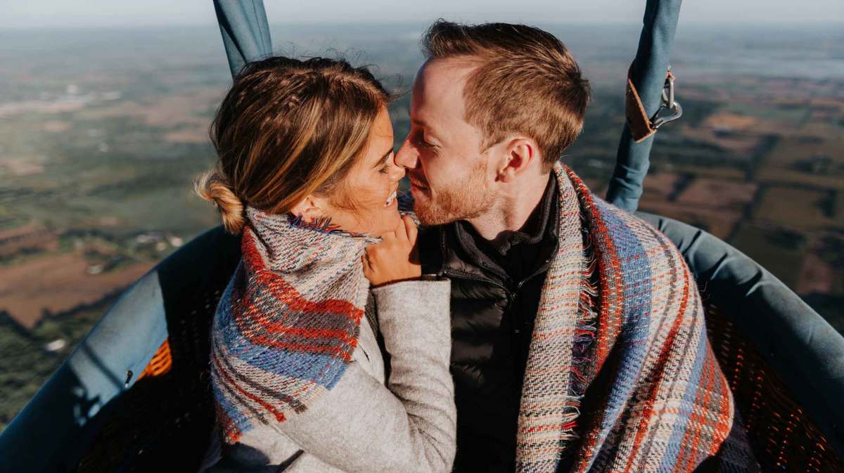 Frau und Mann in einem Heißluftballon.